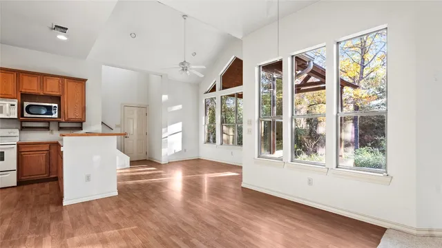 a view of a kitchen with furniture and wooden floor
