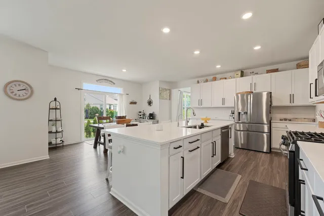 a kitchen with white cabinets and stainless steel appliances