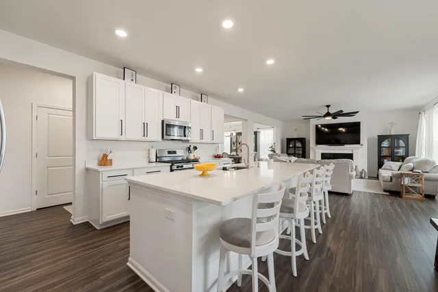 a kitchen with white cabinets and stainless steel appliances