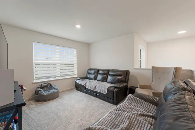 a living room with furniture cabinets and a window