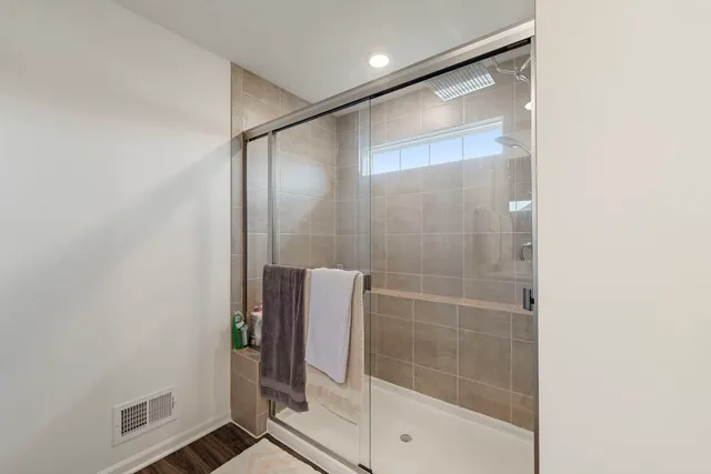 a bathroom with a glass shower door