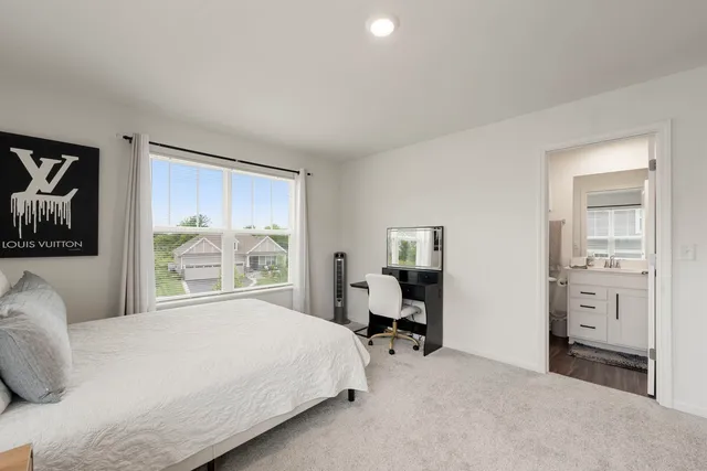 a bedroom with a bed and a large window