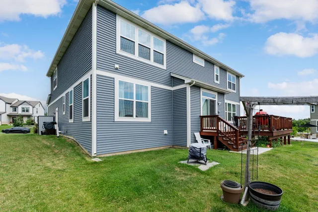 a front view of a house with garden and deck