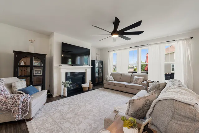 a living room with furniture a flat screen tv and a fireplace