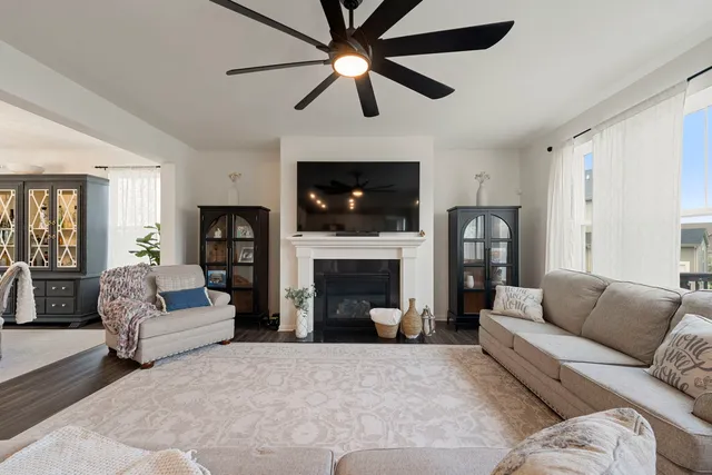 a living room with furniture a fireplace and a flat screen tv