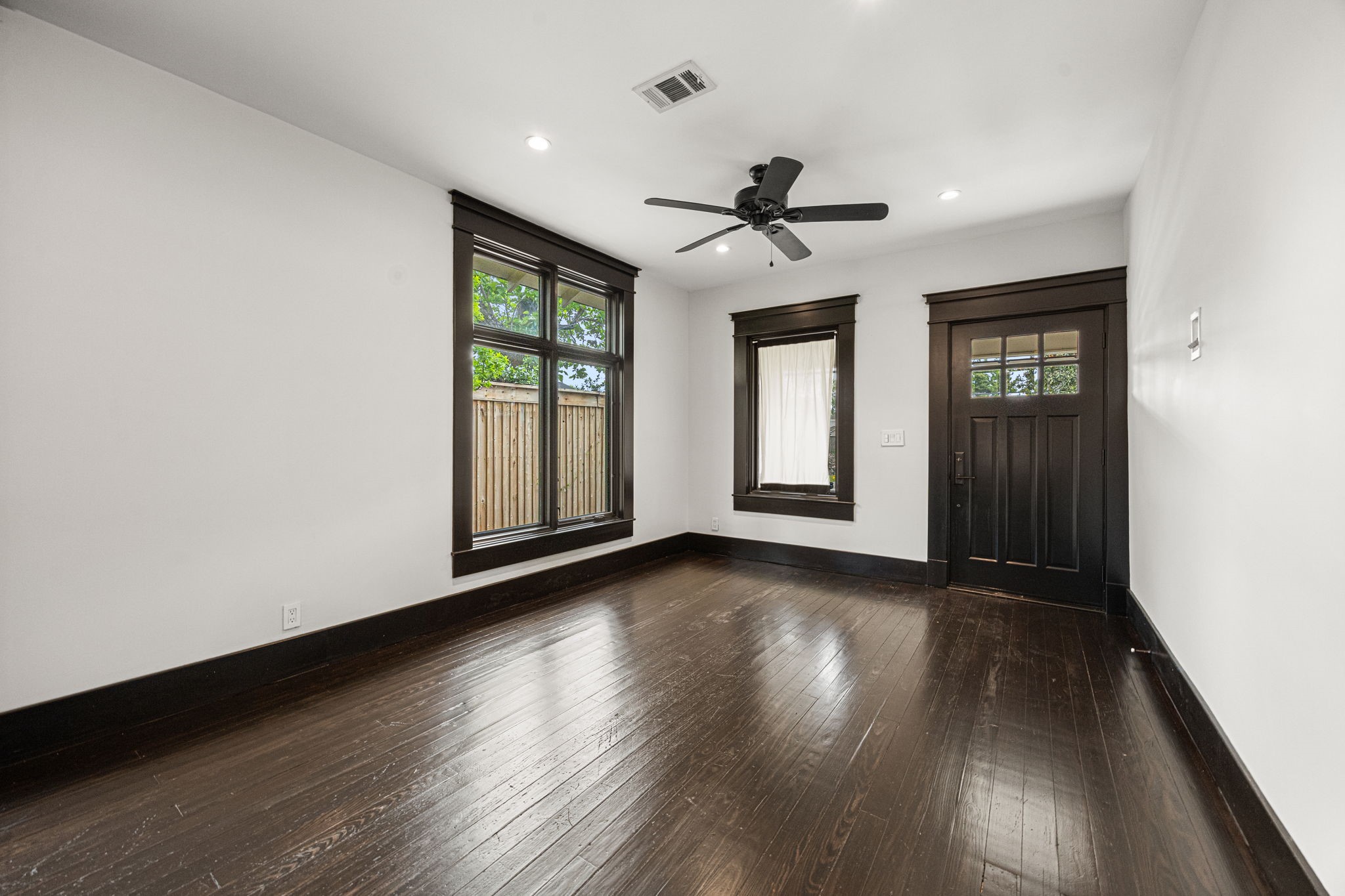 1115 Adele Street Houston, TX 77009 - Photo 6 of 19 Open living and dining area with expansive windows and natural light throughout.