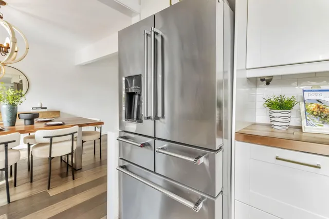 a kitchen with stainless steel appliances granite countertop a refrigerator and a sink
