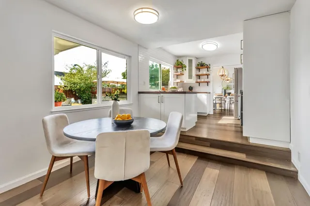 a dining room with furniture and wooden floor
