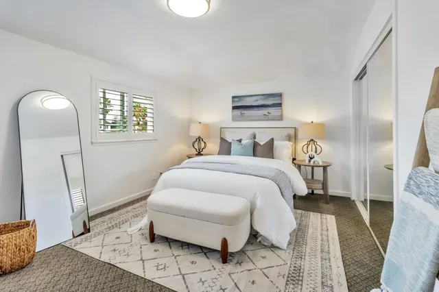 a bedroom with a bed and a mirror