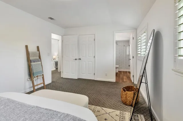 a bedroom with furniture and a window