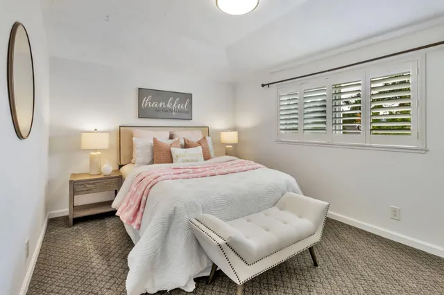 a bedroom with a bed and a table