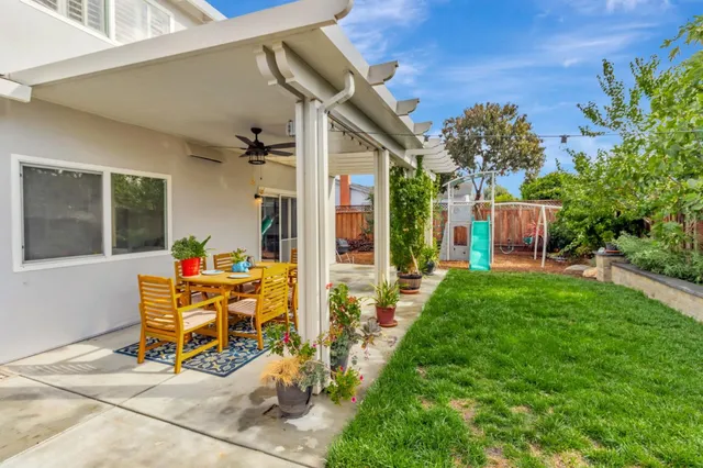 a view of a house with backyard sitting area and garden