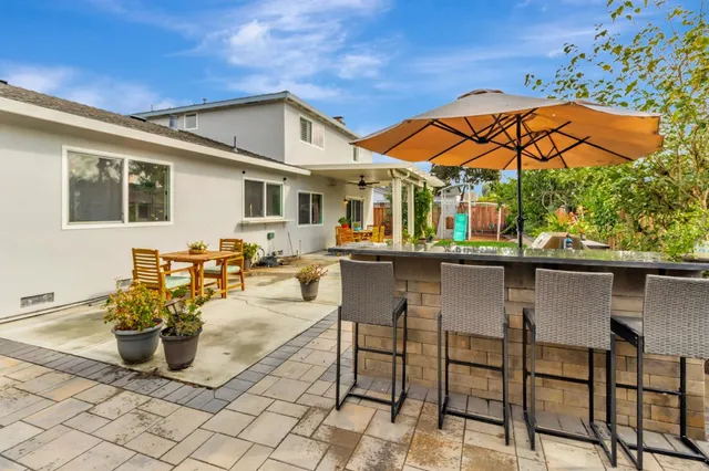 a backyard of a house with table and chairs