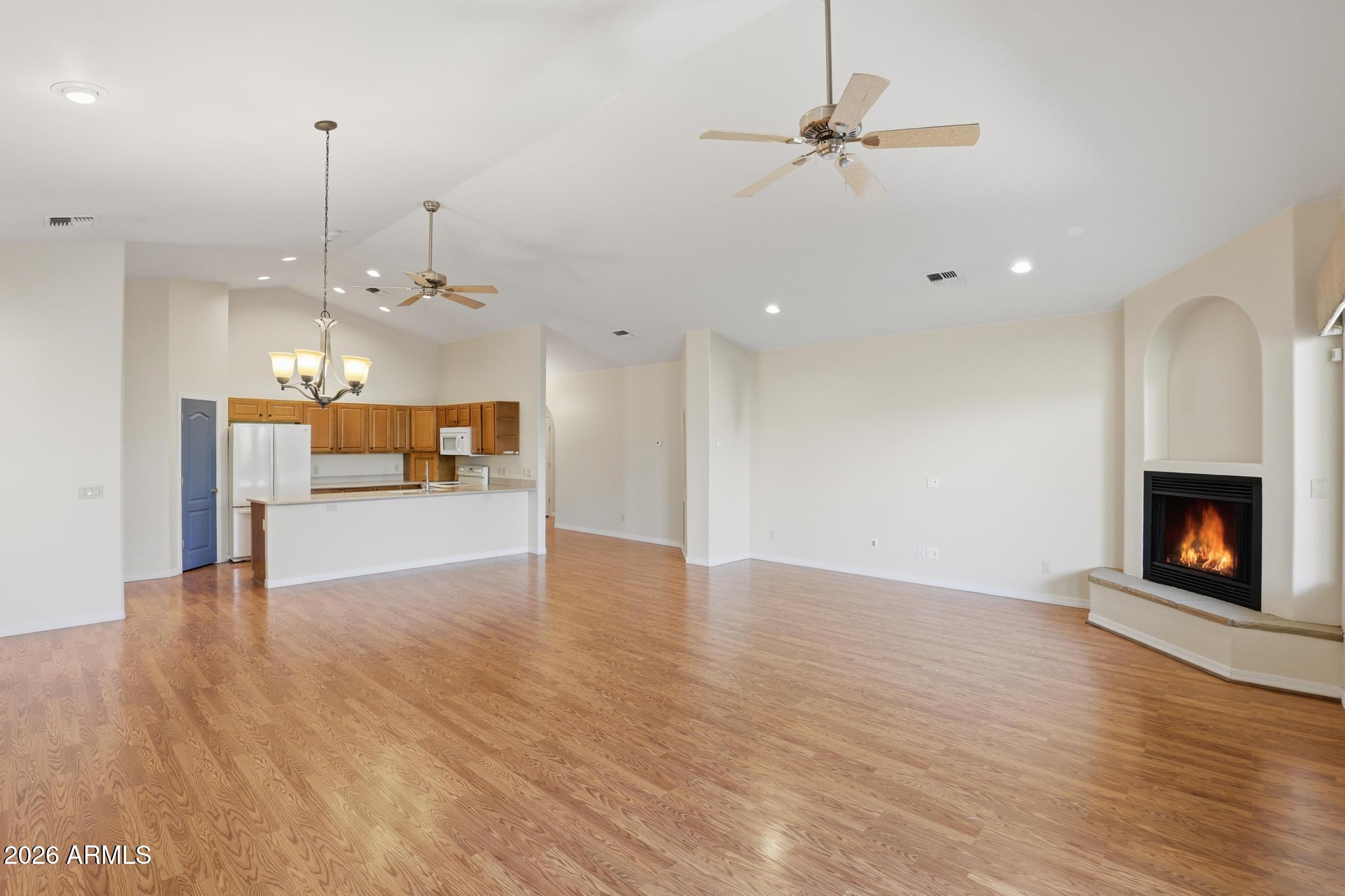408 East Phoenix Street Payson, AZ 85541 - Photo 7 of 35 a view of a kitchen with a fireplace a ceiling fan and wooden floor