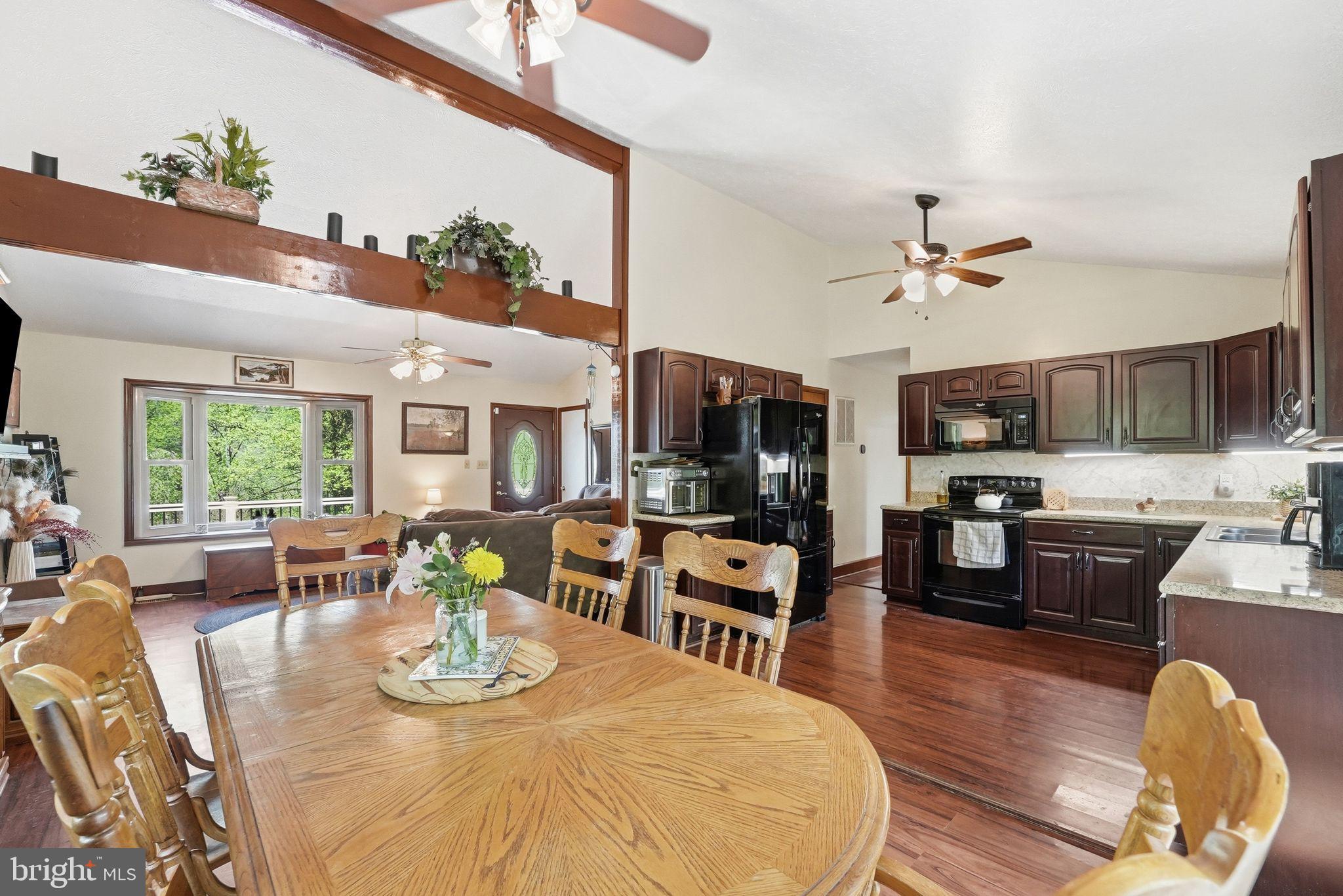 648 Creek Road Front Royal, VA 22630 - Photo 19 of 72 a view of a dining room with furniture a kitchen and chandelier