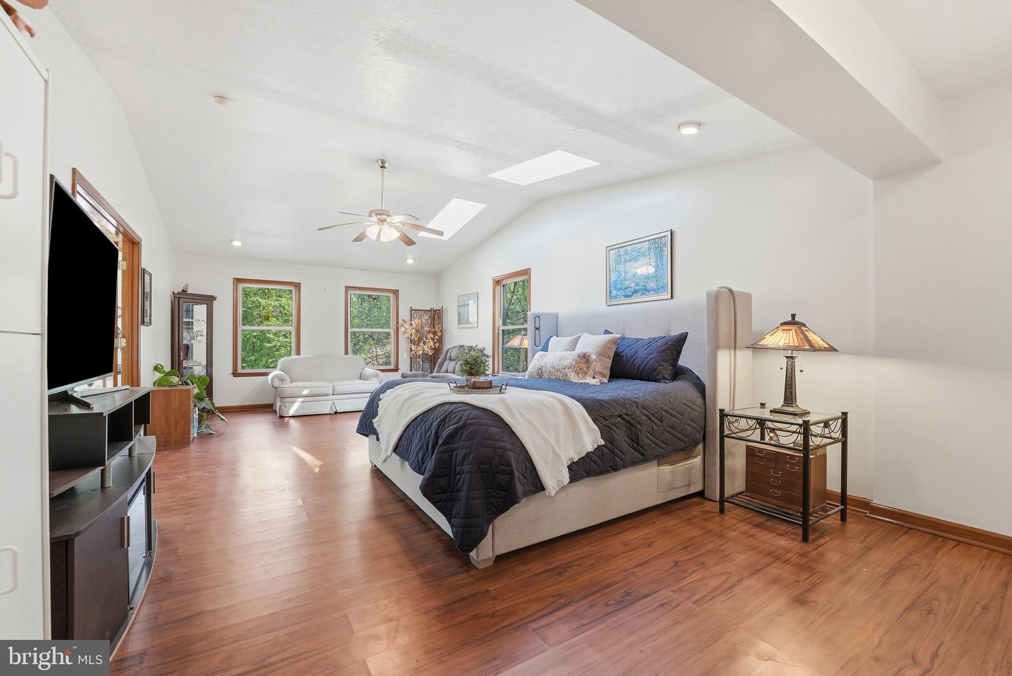 648 Creek Road Front Royal, VA 22630 - Photo 26 of 72 a spacious bedroom with a bed and a flat screen television