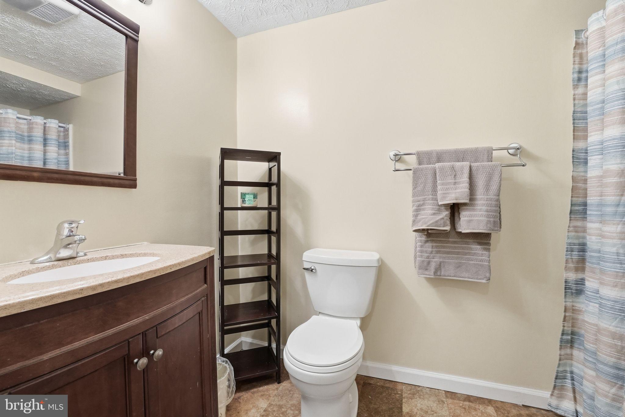 648 Creek Road Front Royal, VA 22630 - Photo 45 of 72 a bathroom with a granite countertop toilet sink and mirror
