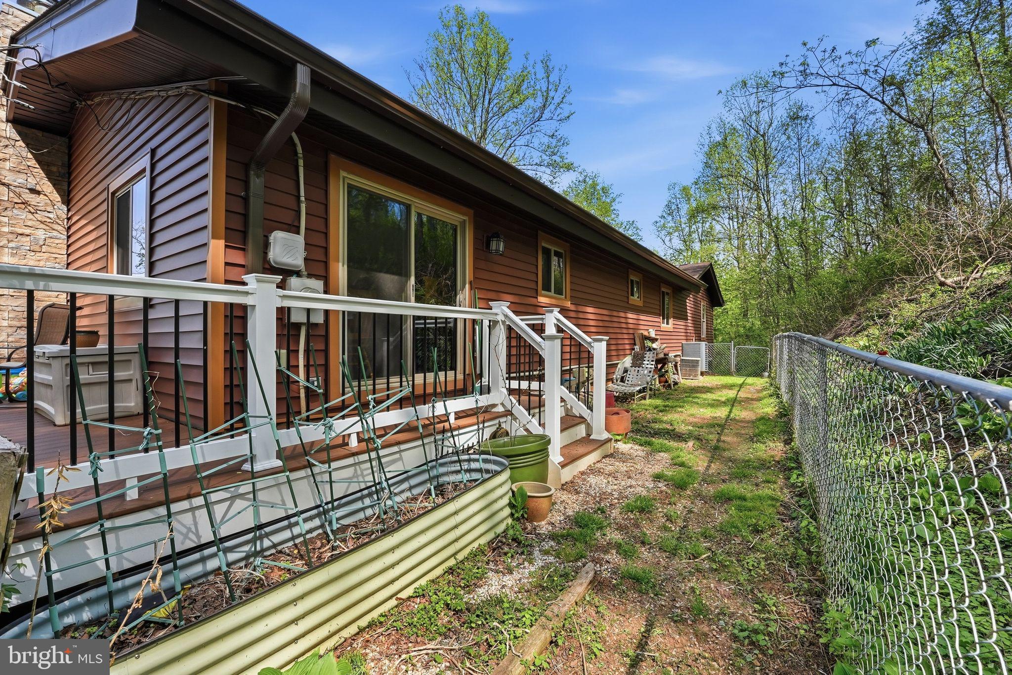 648 Creek Road Front Royal, VA 22630 - Photo 49 of 72 a view of a house with a small yard and wooden fence