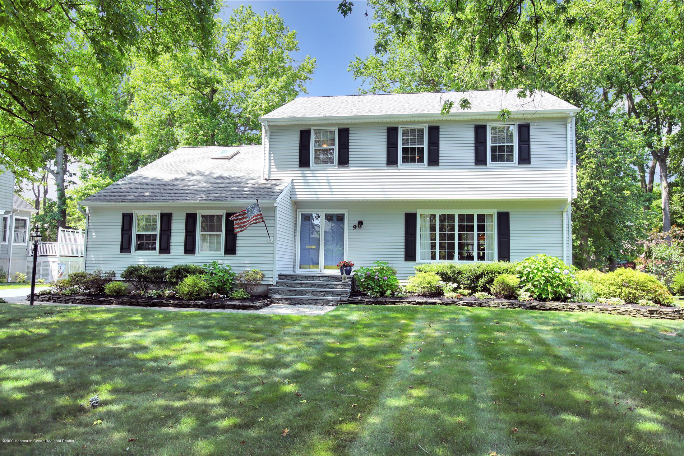 9 Breezy Point Road Little Silver, NJ 07739 - Photo 2 of 32 a front view of a house with a yard and potted plants