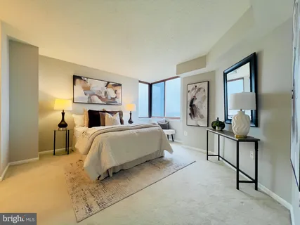 a bedroom with a bed and a mirror