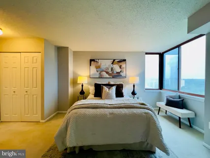 a bed sitting in a bedroom next to a window