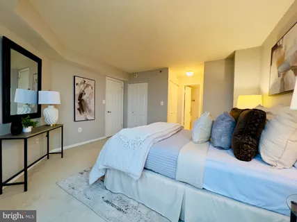 a bedroom with a large bed and a dresser