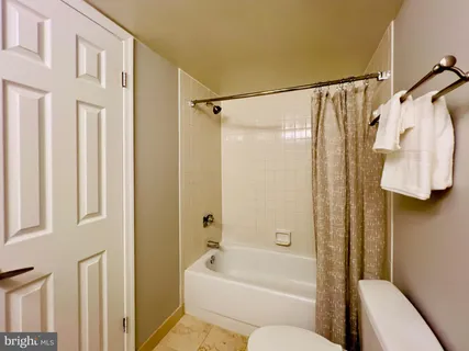 a bathroom with a shower curtain and a sink