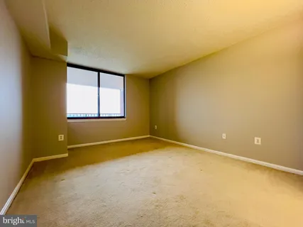 an empty room with a empty space and a window