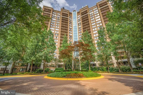 a view of a tall building next to a road