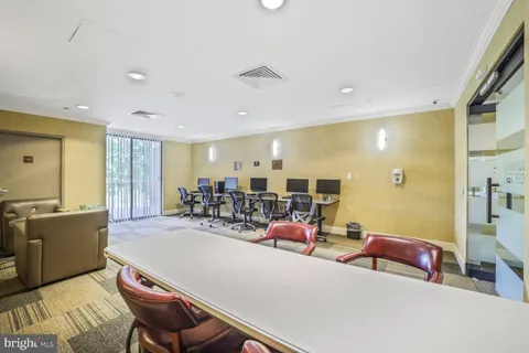 a view of a dining room with furniture and a chandelier