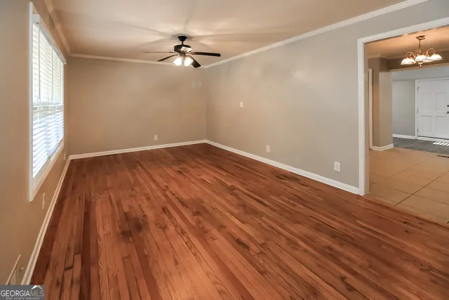 wooden floor in an empty room with a window