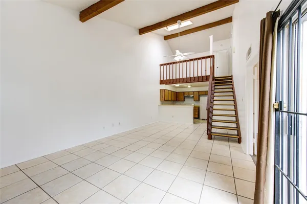a view of a hallway with stairs and a window