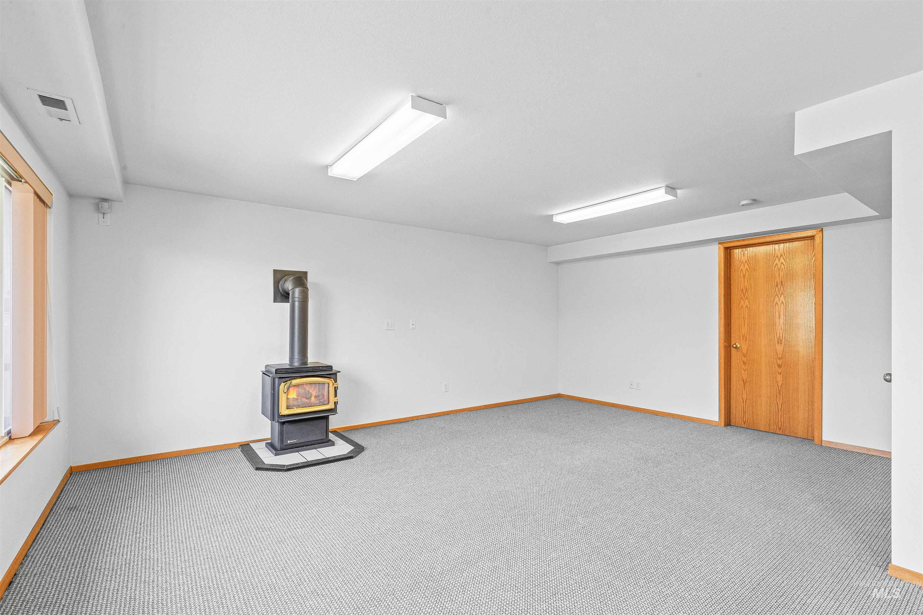 1962 Golfview Drive Clarkston, WA 99403 - Photo 29 of 35 Finished below grade area with a wood stove and carpet flooring