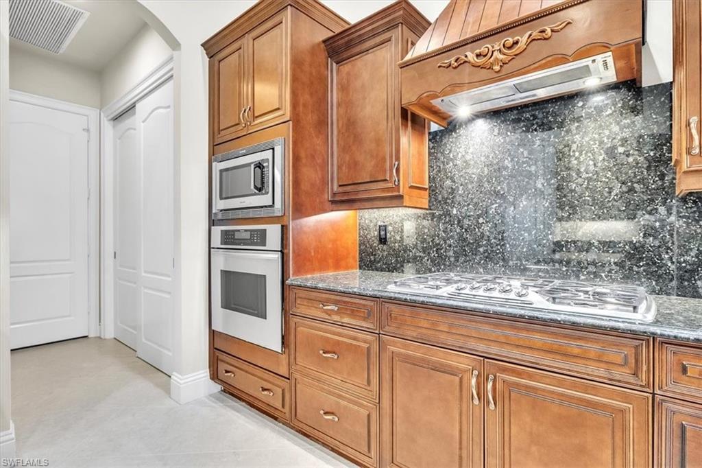 3331 Sanctuary Point Fort Myers, FL 33905 - Photo 12 of 50 a kitchen with granite countertop white cabinets and stainless steel appliances