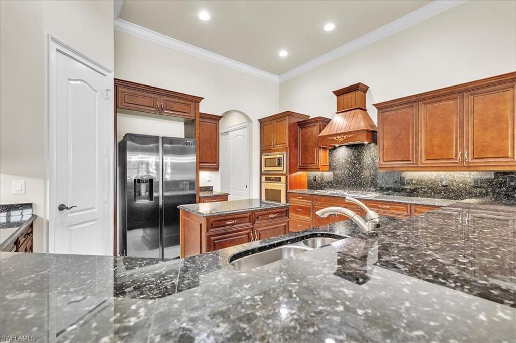 3331 Sanctuary Point Fort Myers, FL 33905 - Photo 14 of 50 a kitchen with stainless steel appliances granite countertop a refrigerator and a sink