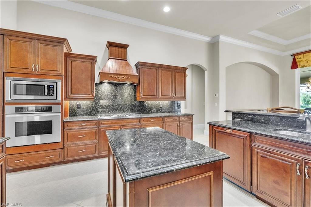 3331 Sanctuary Point Fort Myers, FL 33905 - Photo 16 of 50 a kitchen with stainless steel appliances granite countertop a stove a sink and a microwave