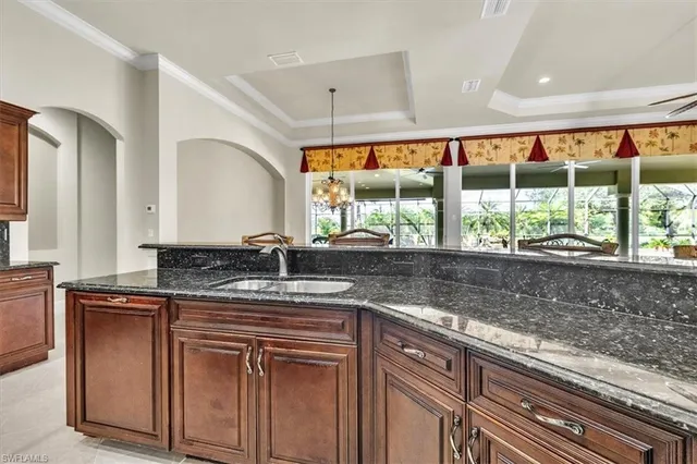 a kitchen with granite countertop a sink and a large window