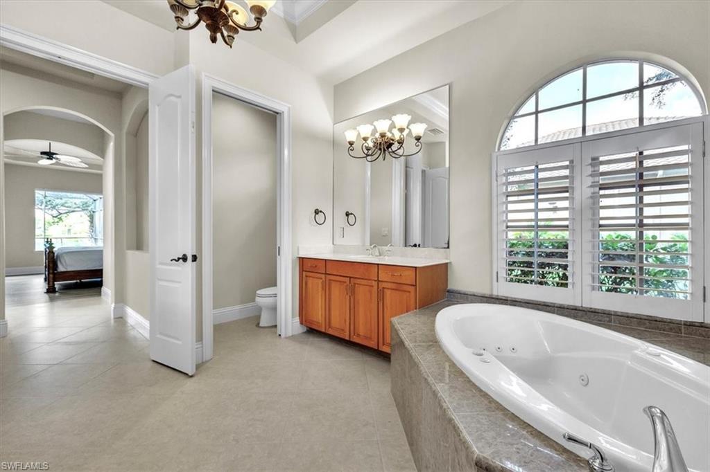 3331 Sanctuary Point Fort Myers, FL 33905 - Photo 28 of 50 a bathroom with a tub a double vanity sink a vanity and a large mirror