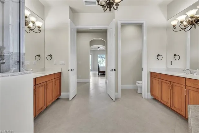 a large en suite bathroom with a sink and a large mirror