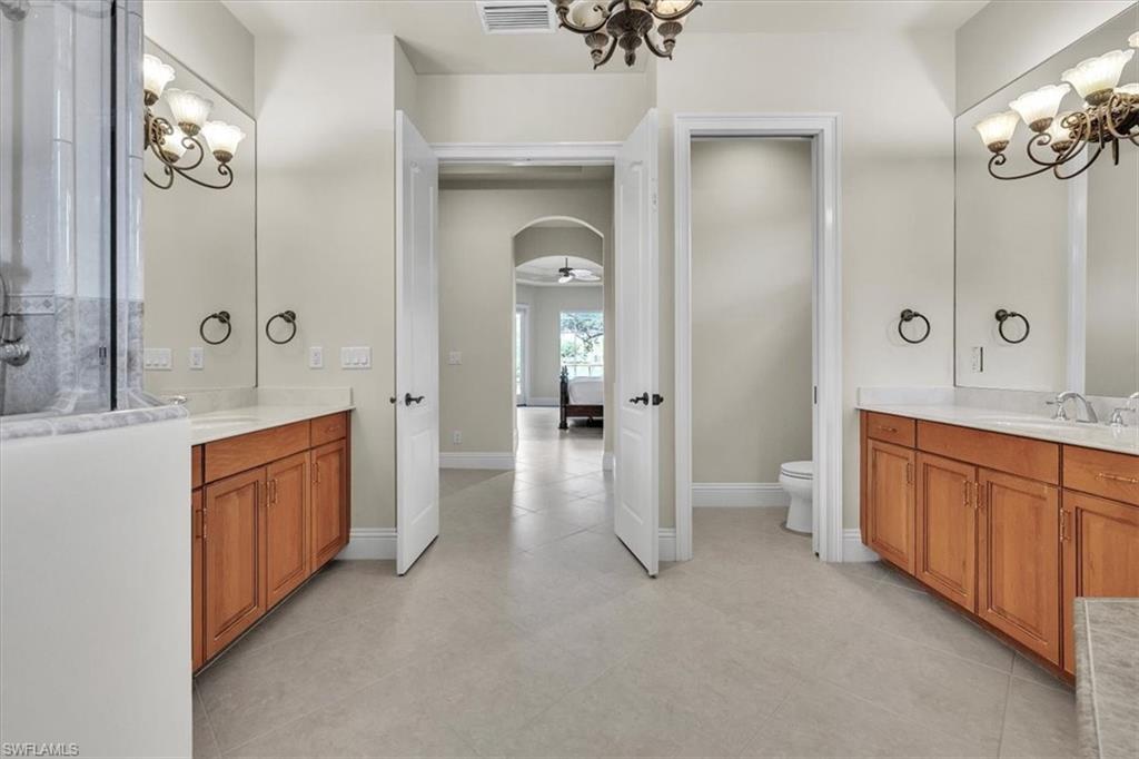 3331 Sanctuary Point Fort Myers, FL 33905 - Photo 30 of 50 a large en suite bathroom with a sink and a large mirror