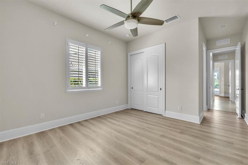 3331 Sanctuary Point Fort Myers, FL 33905 - Photo 34 of 50 a view of an empty room with wooden floor and a window