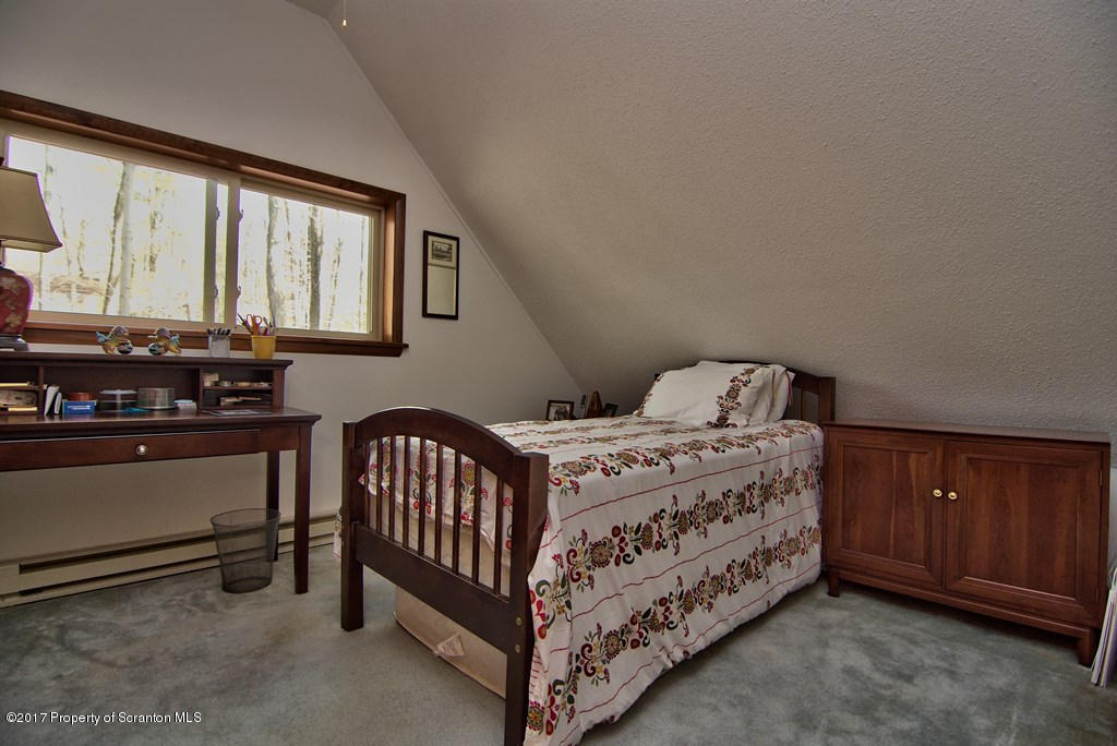 3304 Northgate Road Lake Ariel, PA 18436 - Photo 21 of 26 a bed sitting in a bedroom next to a window