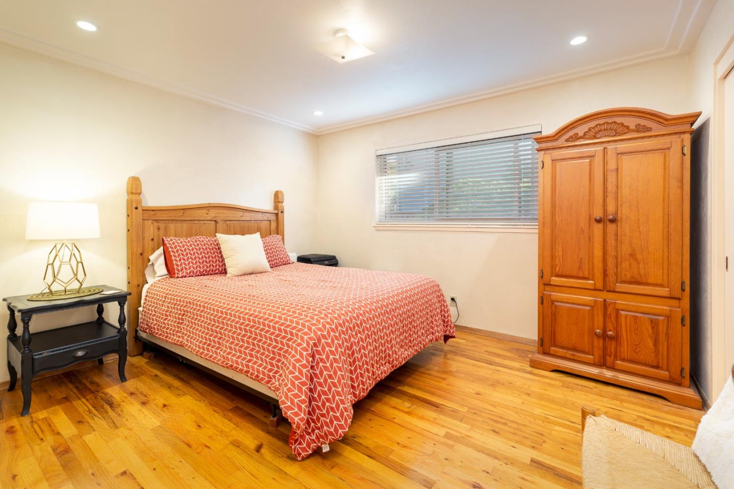 26436 Oliver Road Carmel, CA 93923 - Photo 23 of 25 a bedroom with a bed and wooden floor