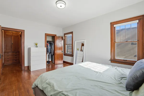 a bedroom with a bed and a dresser