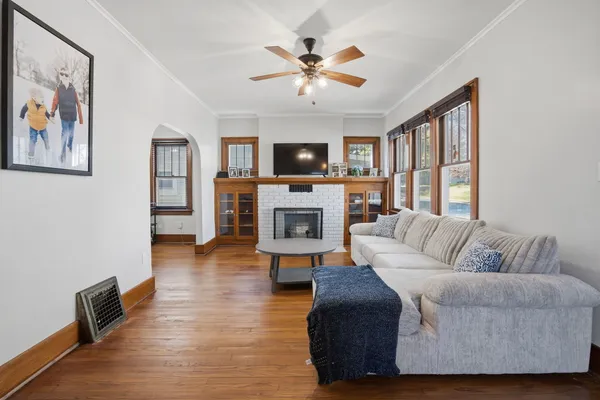 a living room with furniture a fireplace and a flat screen tv