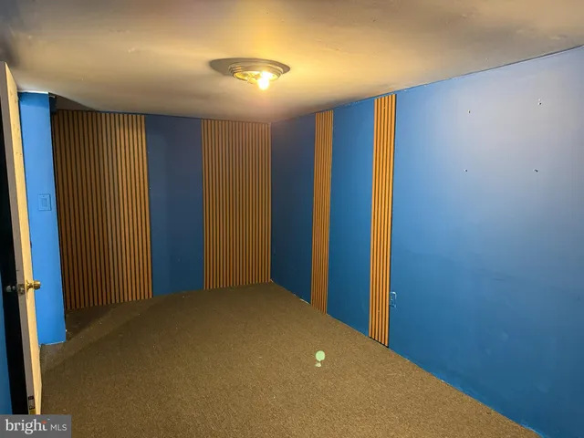 a bathroom with a granite countertop shower and a mirror