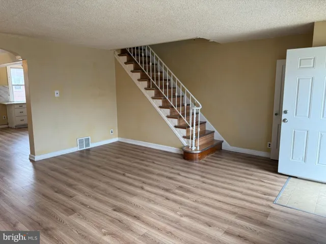 a view of an entryway with wooden floor