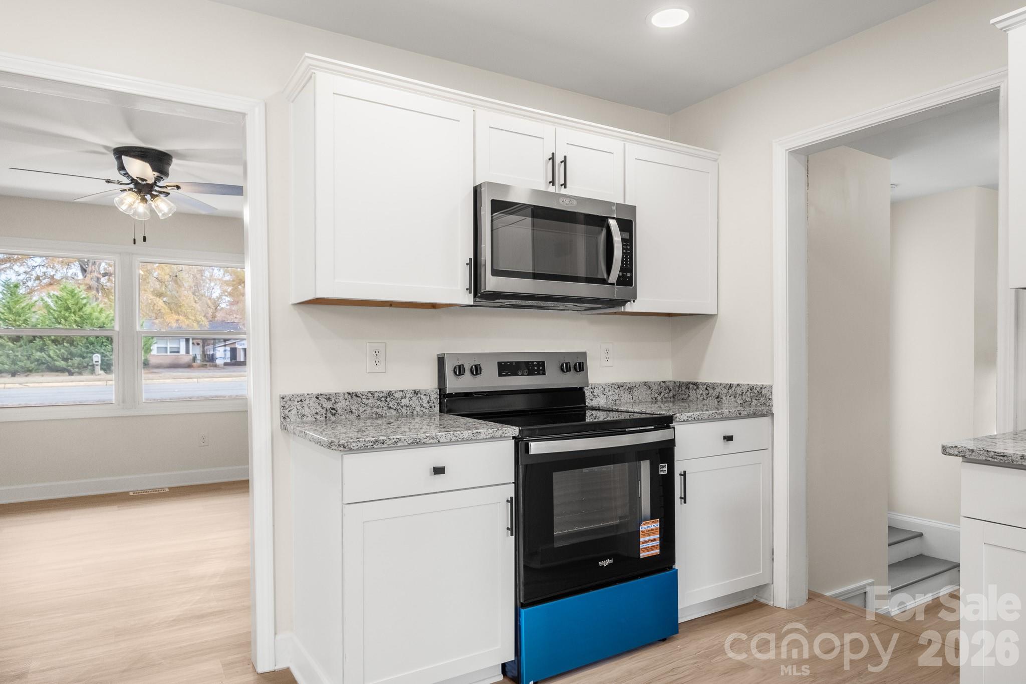 1152 Mt Holly Road Rock Hill, SC 29730 - Photo 12 of 41 a kitchen with stainless steel appliances granite countertop a stove a sink and a microwave