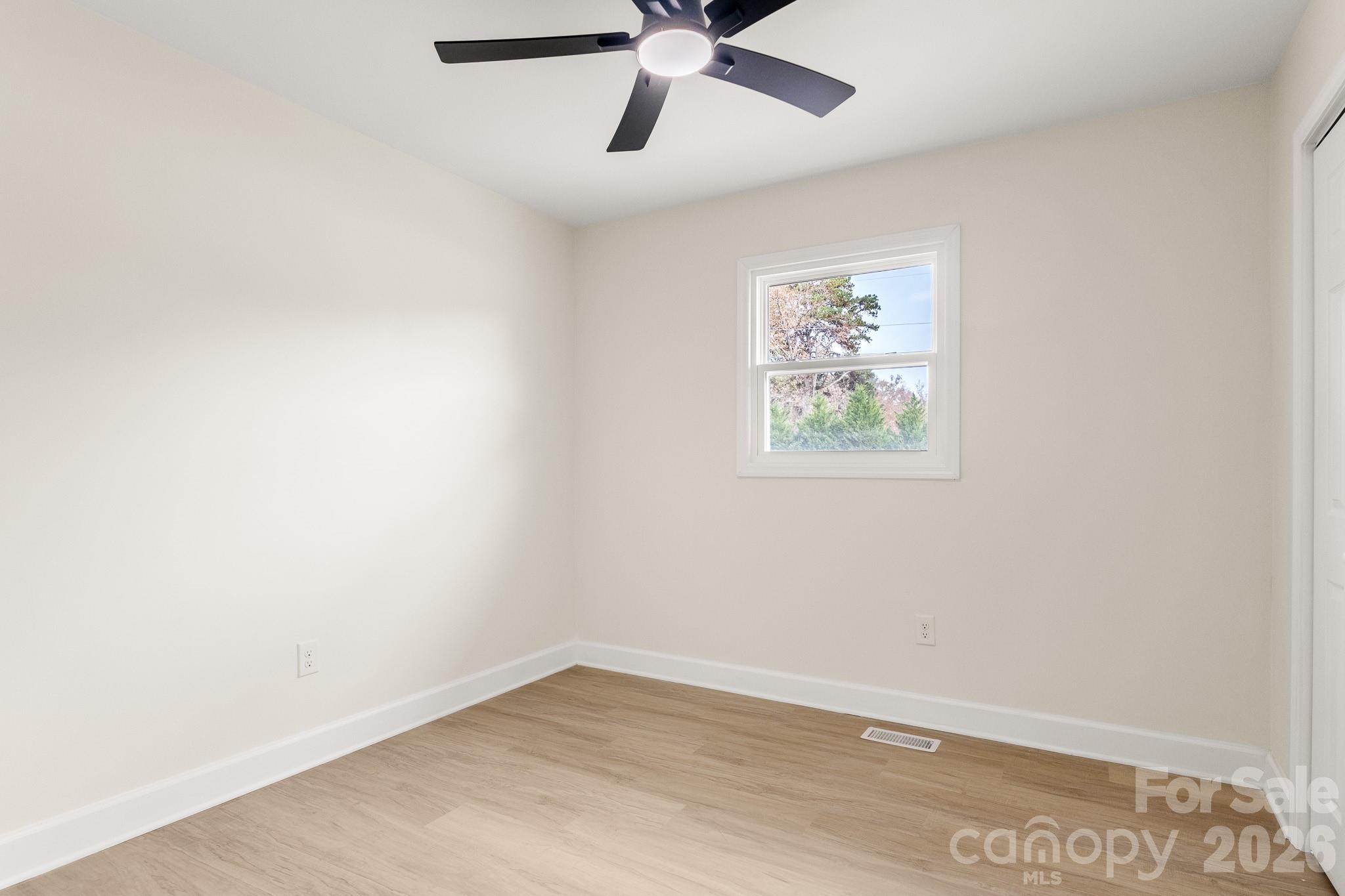 1152 Mt Holly Road Rock Hill, SC 29730 - Photo 26 of 41 an empty room with a window and a ceiling fan