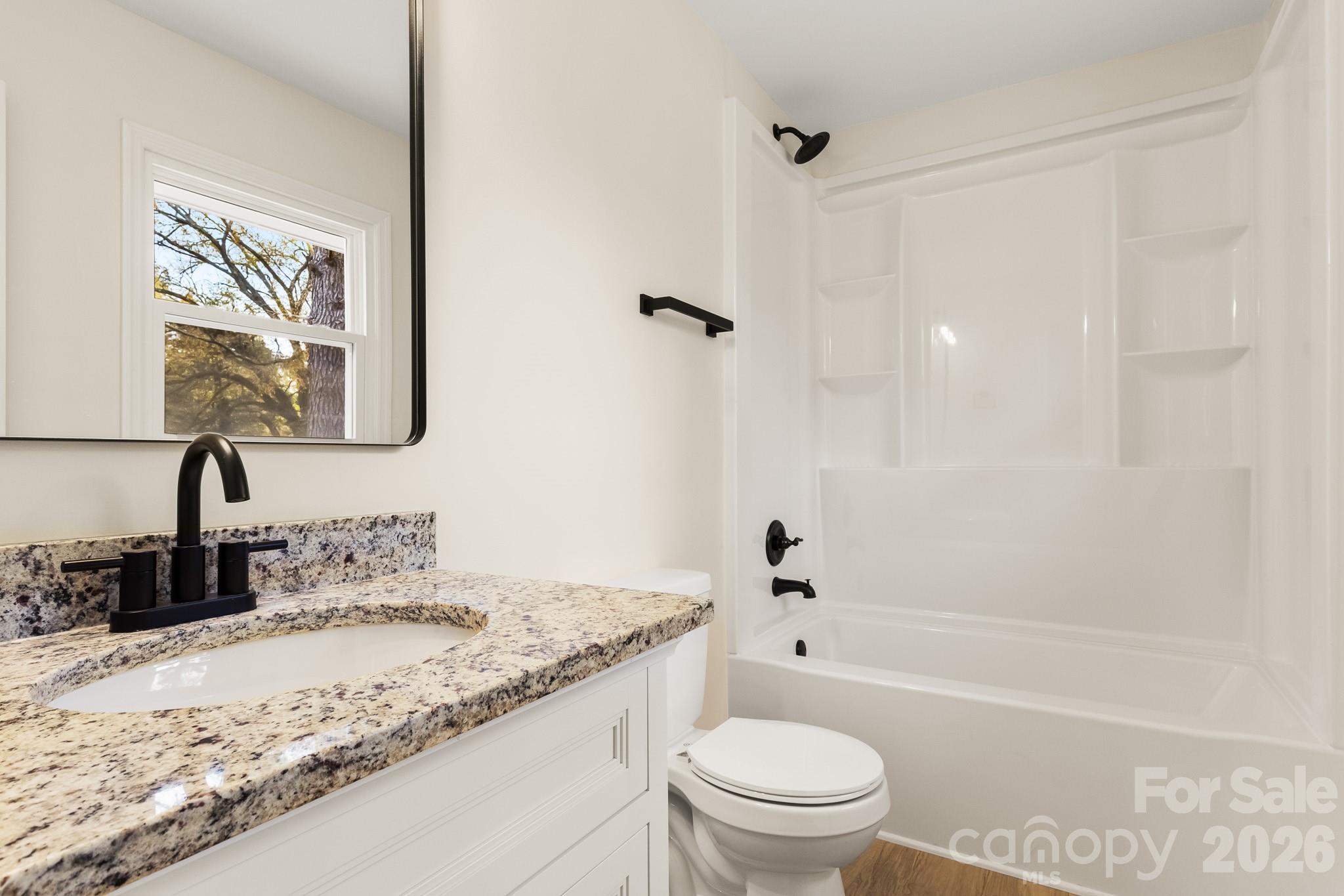 1152 Mt Holly Road Rock Hill, SC 29730 - Photo 33 of 41 a bathroom with a granite countertop sink a toilet and shower